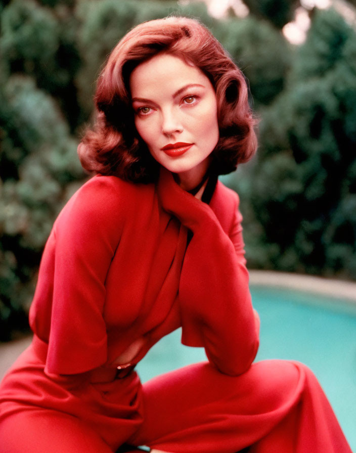 Short Wavy-Haired Woman in Red Outfit Poses by Poolside