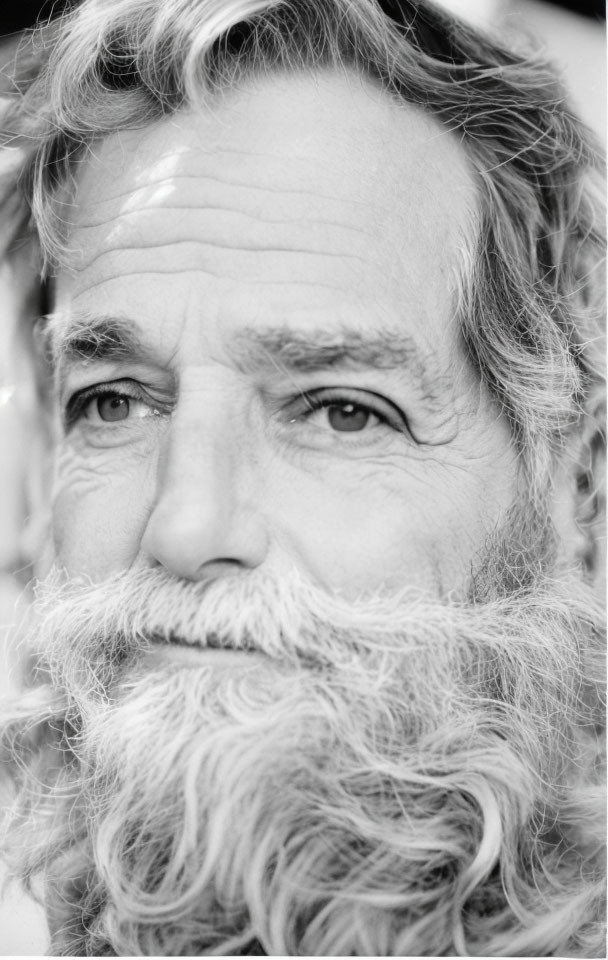 Elderly man with full beard and mustache in black and white portrait