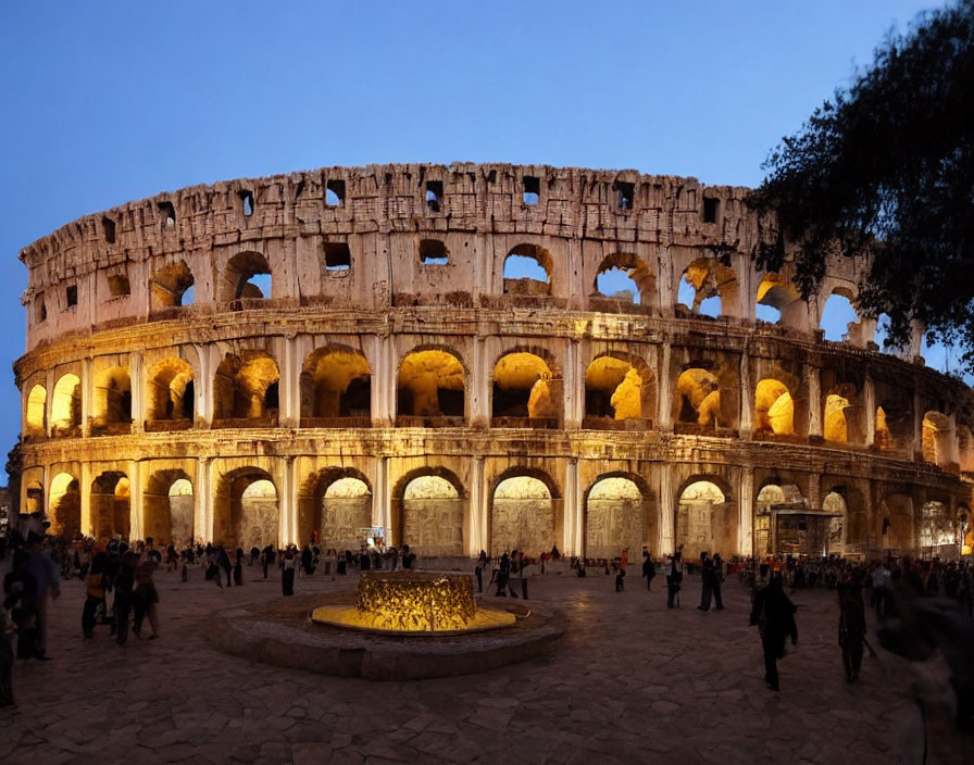 Ancient Roman Colosseum illuminated at dusk with tourists.