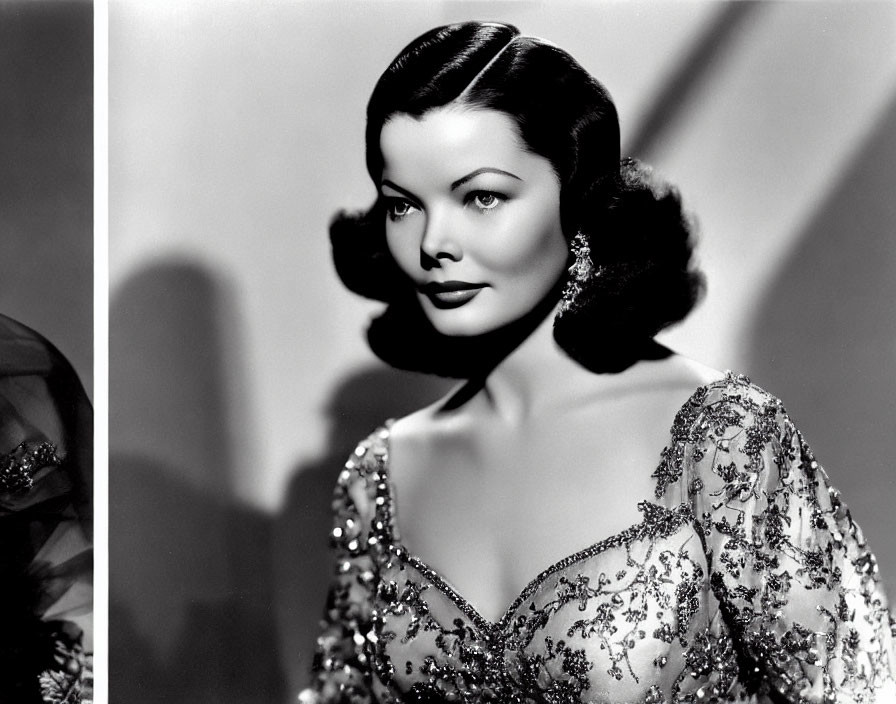 Vintage black and white portrait of glamorous woman in sequined dress with wavy hair