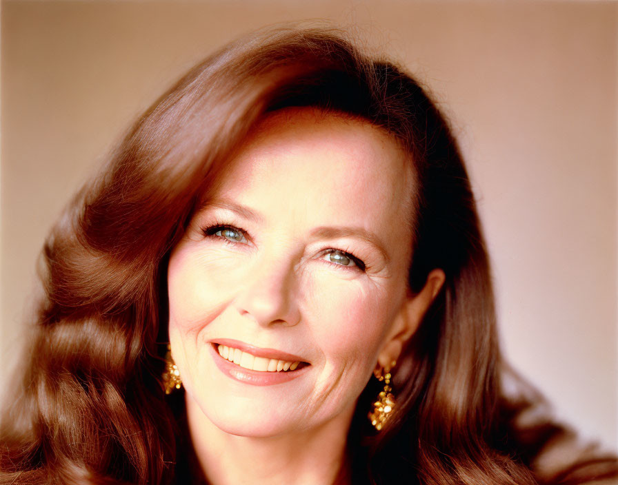 Smiling woman with fair skin, red lipstick, dangling earrings