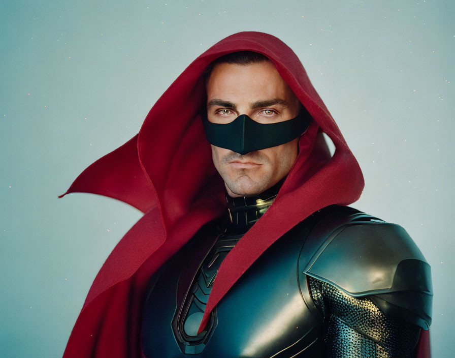 Superhero in red cape and black mask on blue background