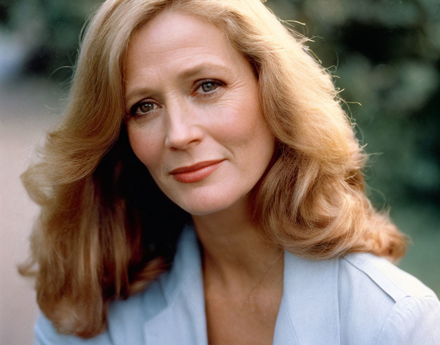 Smiling woman with blonde hair in light blue blazer