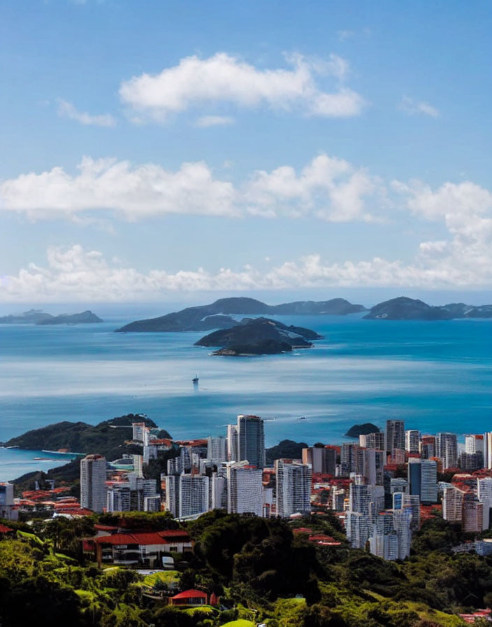 Coastal city skyline with high-rise buildings, greenery, islands, sea, and skies