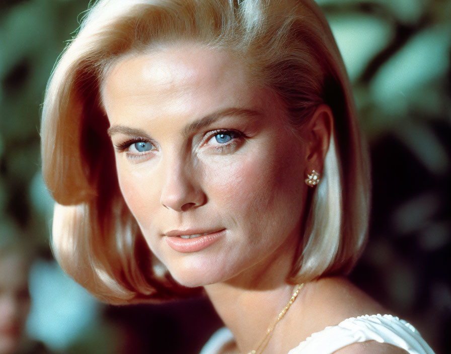 Blonde woman with diamond earrings in foliage setting