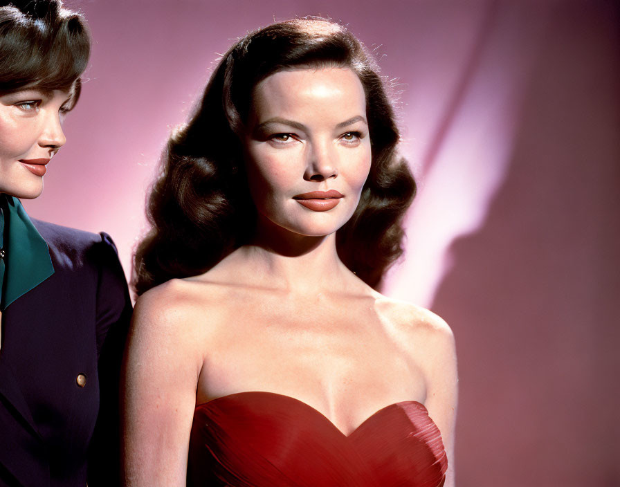 Two women in vintage attire with elegant hairstyles on pink backdrop