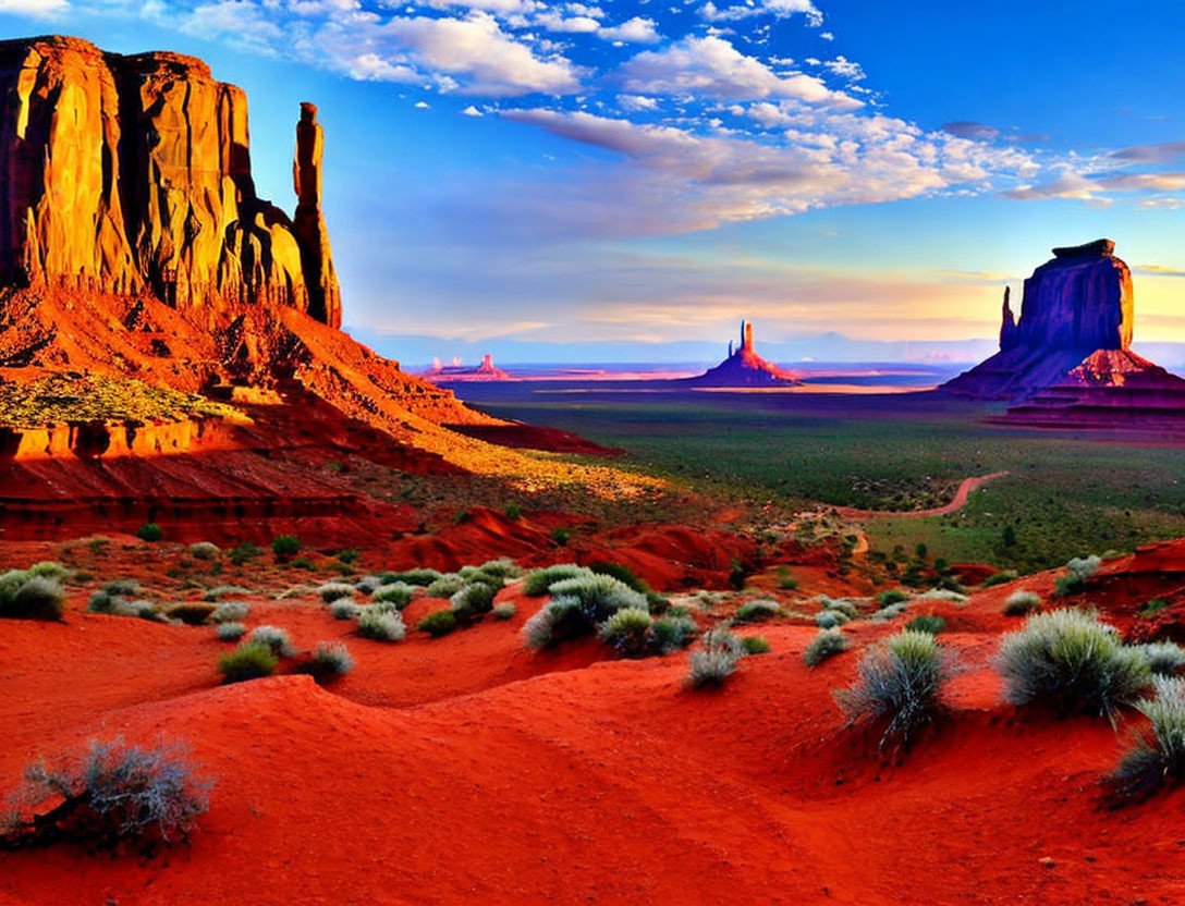 Red Sand Desert Landscape with Towering Rock Formations at Sunset