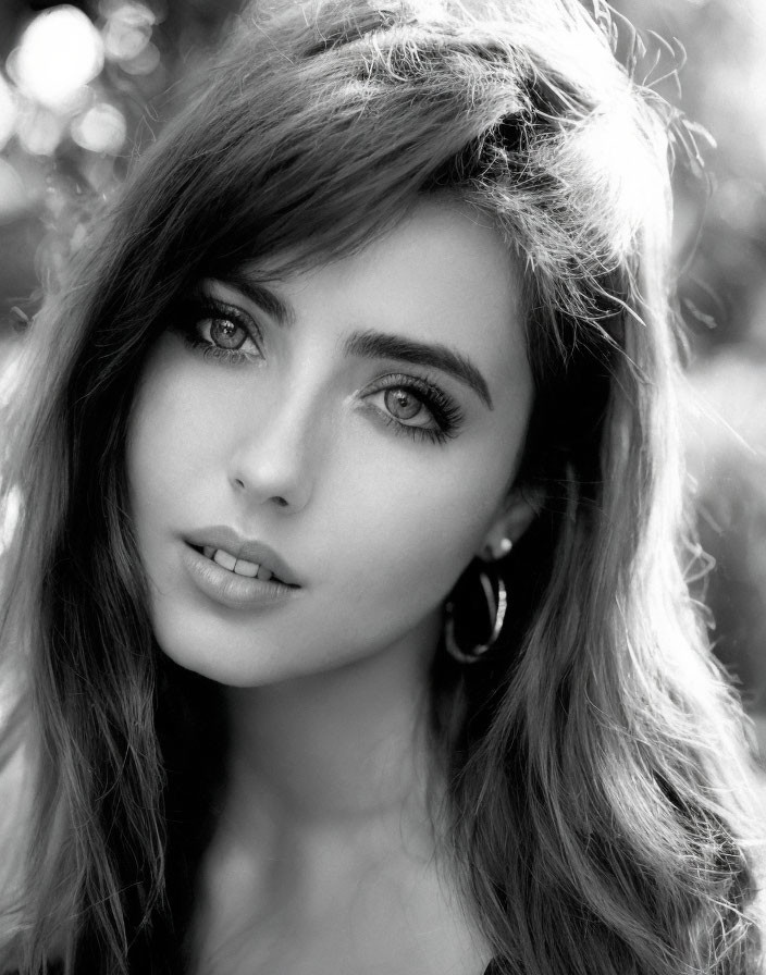 Monochrome portrait of woman with dark hair and striking makeup