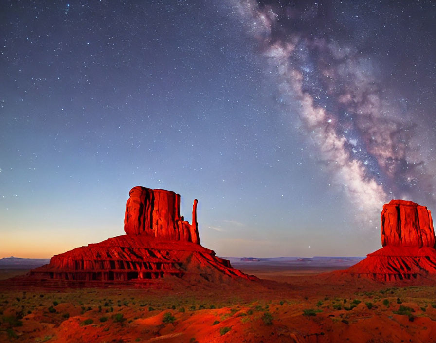 Starry Night Sky Over Rocky Buttes in Desert Landscape