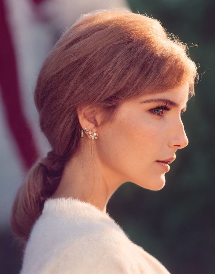 Woman with Auburn Hair in Braid Wearing White Sweater and Earring