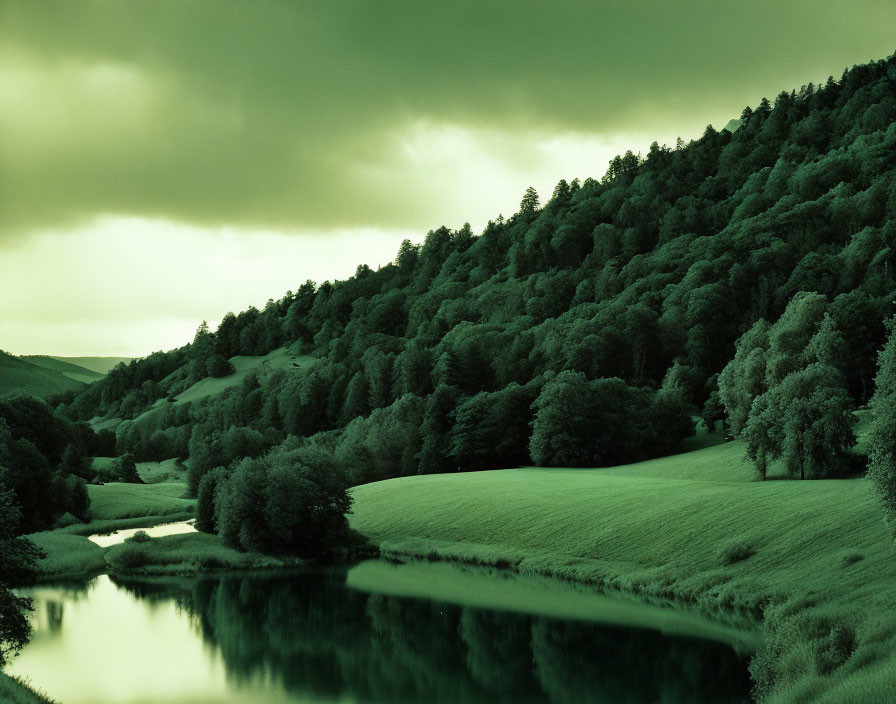 Monochrome landscape with serene river, rolling hills, and cloudy sky