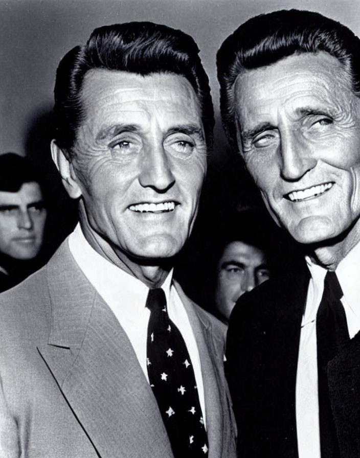 Two Smiling Older Men in Suits, Resembling Each Other closely