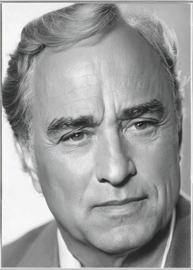 Monochrome close-up of mature man with wrinkles and receding hairline