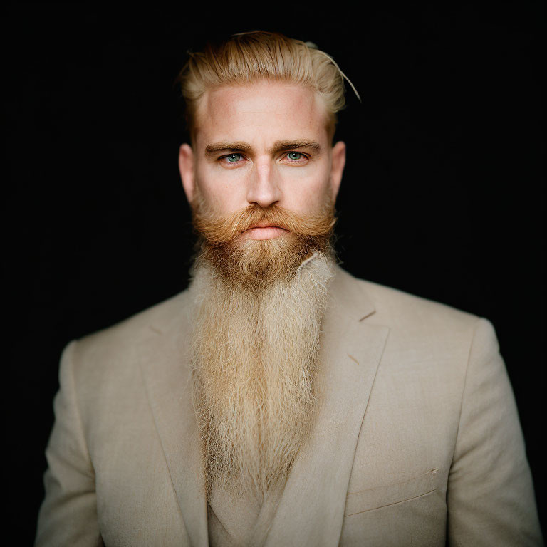 Man with Long Beard in Beige Suit on Black Background