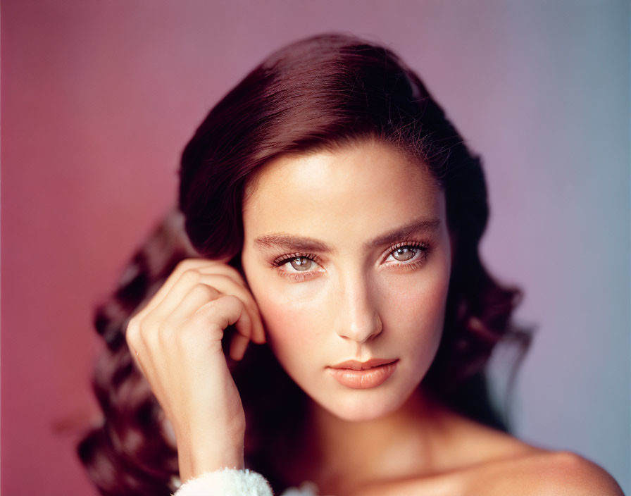 Woman with Wavy Hair and Intense Gaze on Pink-Purple Gradient Background