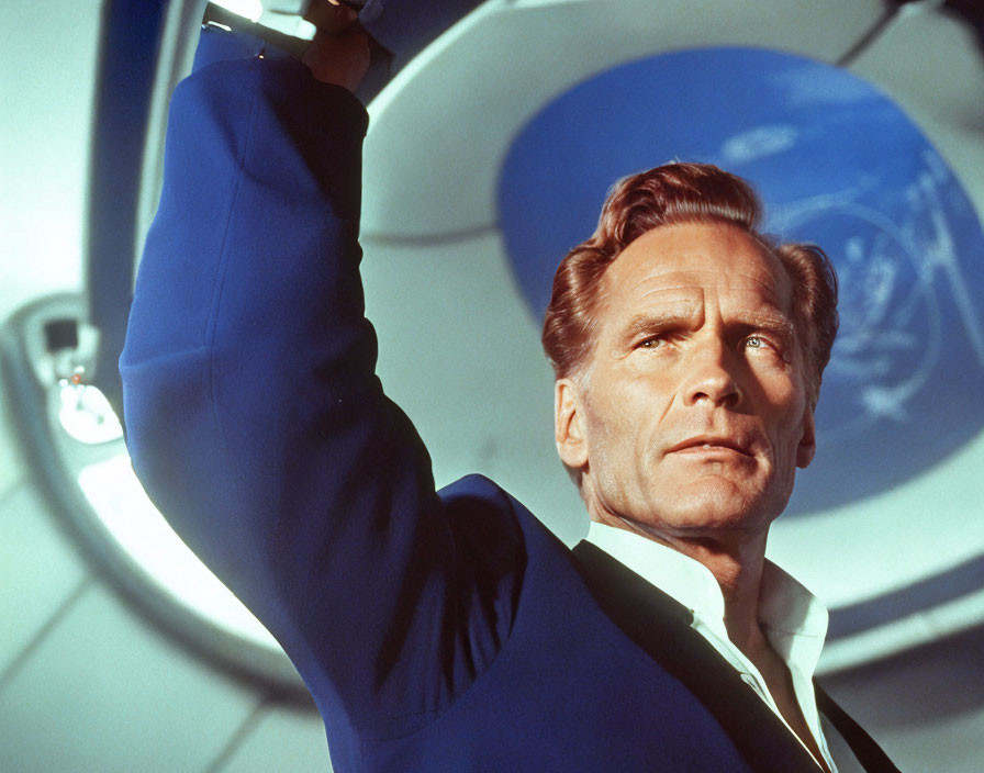 Man in blue suit on spacecraft with futuristic interior