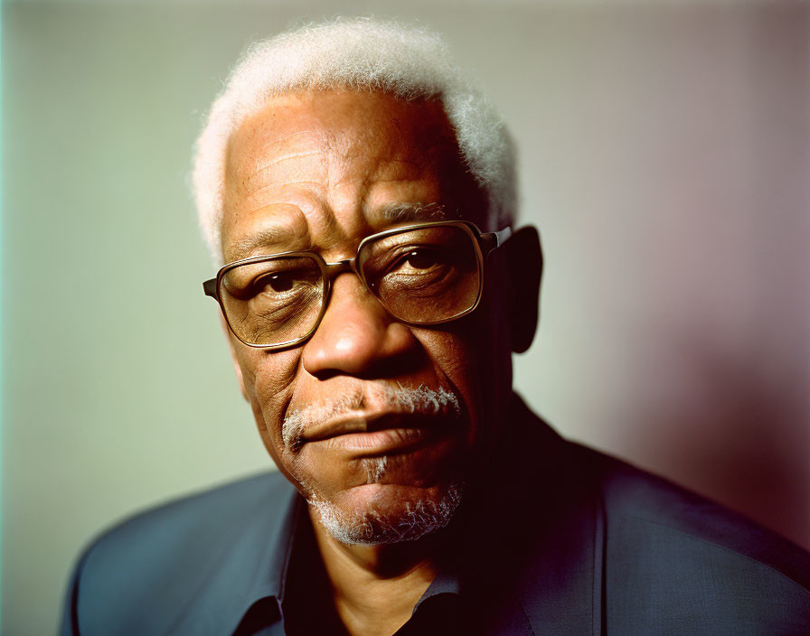 Elderly man portrait with white hair and glasses