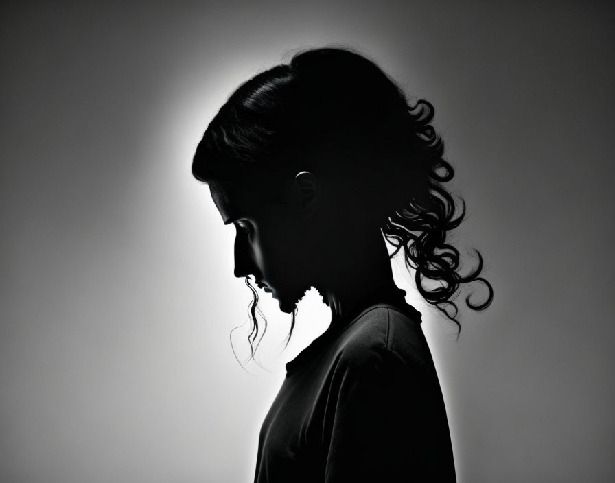 Silhouetted Woman Profile with Light Outlining Features