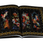 Illustrated open book with medieval women in ornate borders