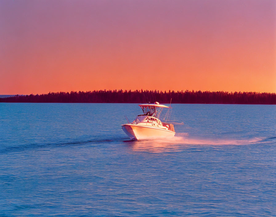 White Speedboat Sailing on Calm Sunset Waters