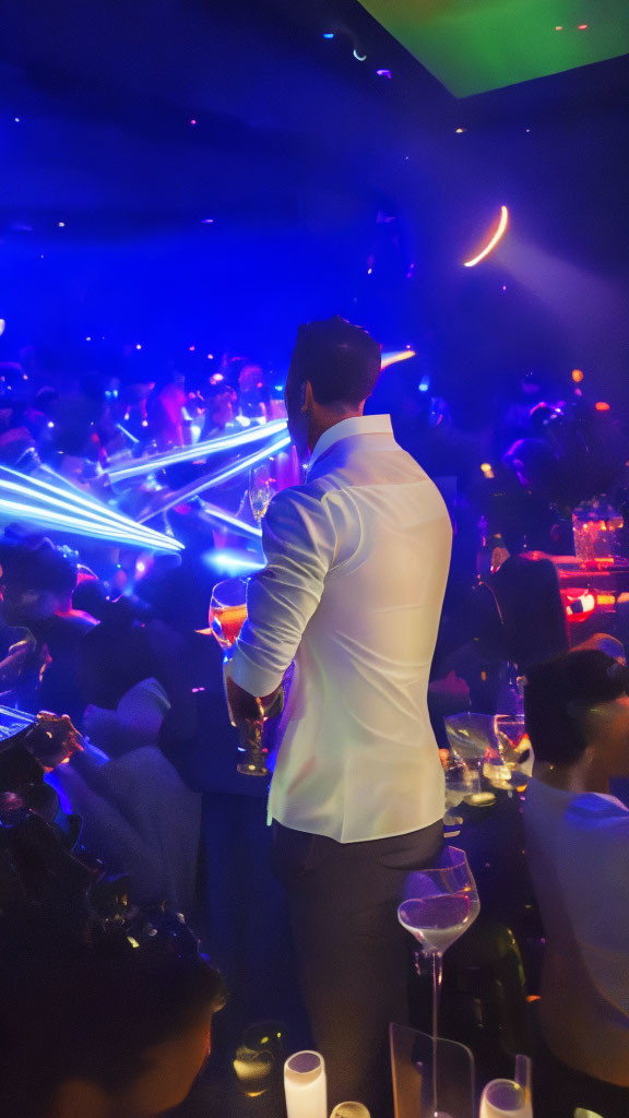Man in White Suit in Nightclub with Blue and Purple Lights
