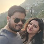 Smiling couple selfie with snowy mountain background