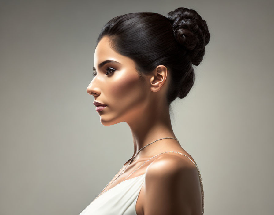 Profile of Woman in Off-Shoulder Dress with Sleek Bun Hairstyle