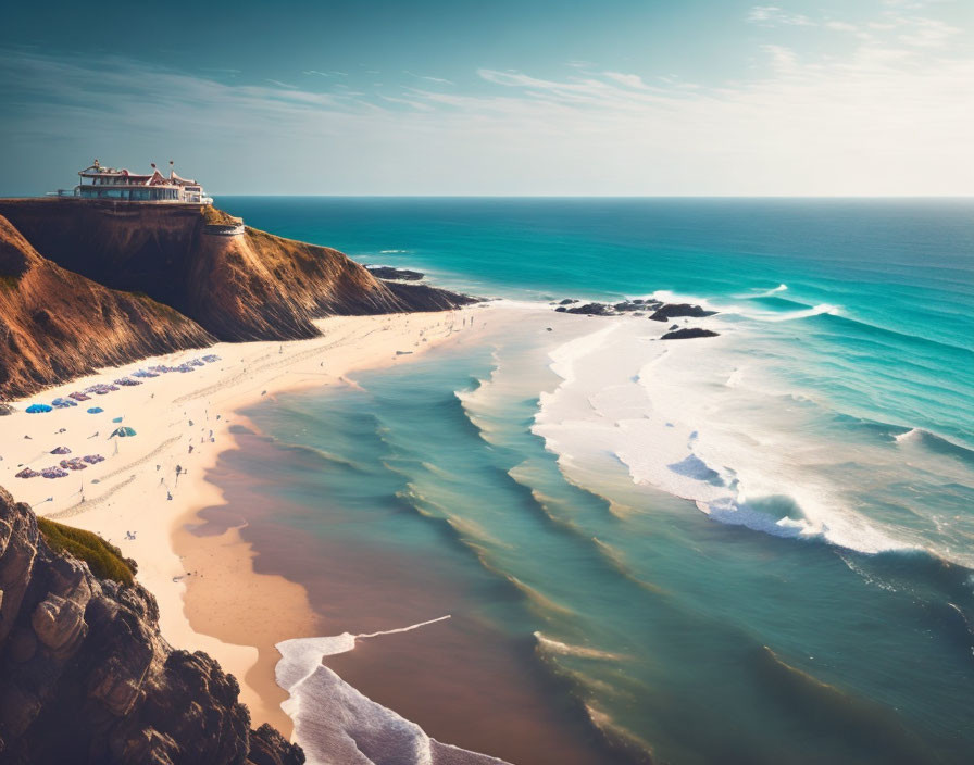 Coastal Beach Scene: Sandy shore, turquoise waters, cliff-top building, clear sky