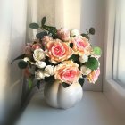 Pink roses in a vase on draped cloth against ornate background