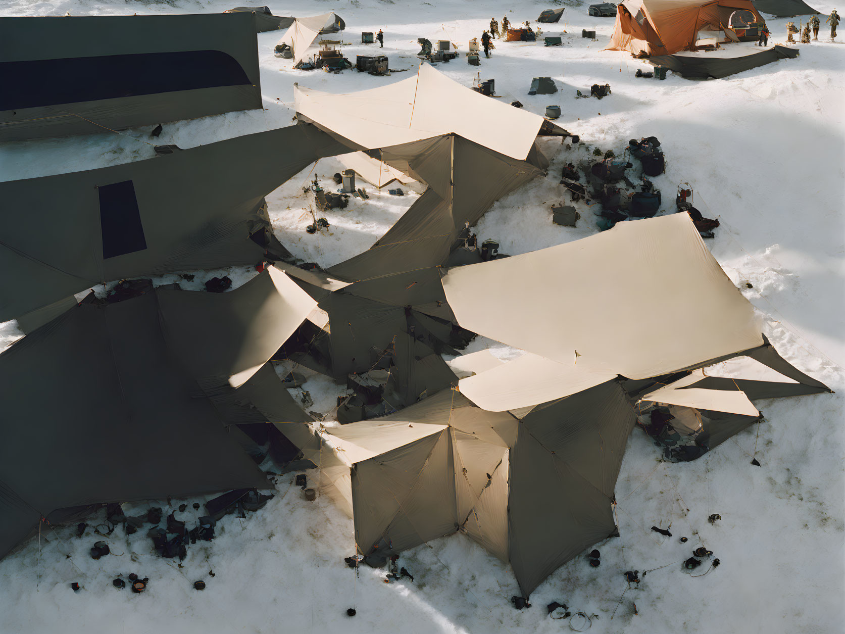 Snowy Camping Site with Tents and People in Aerial View