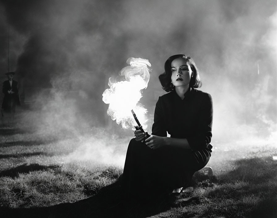 Woman in dark outfit with smoking gun in atmospheric smoke