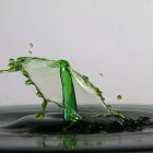 Water Droplet Collision Creates Green Liquid Splash on Gray Background