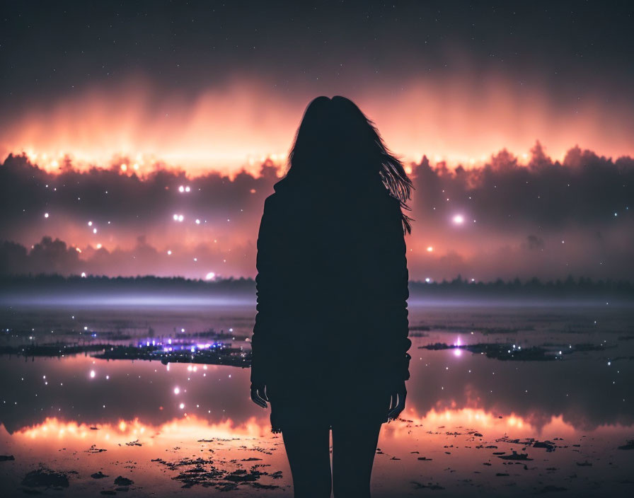 Solitary figure under starry night sky reflected in water