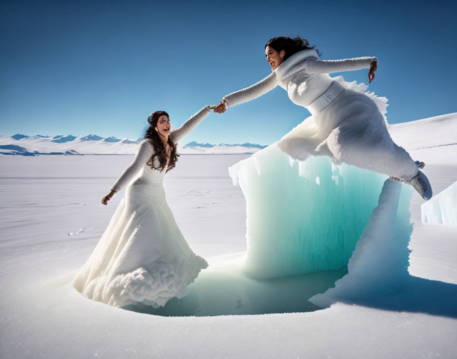 Two women in white dresses on snowy landscape with blue ice formation