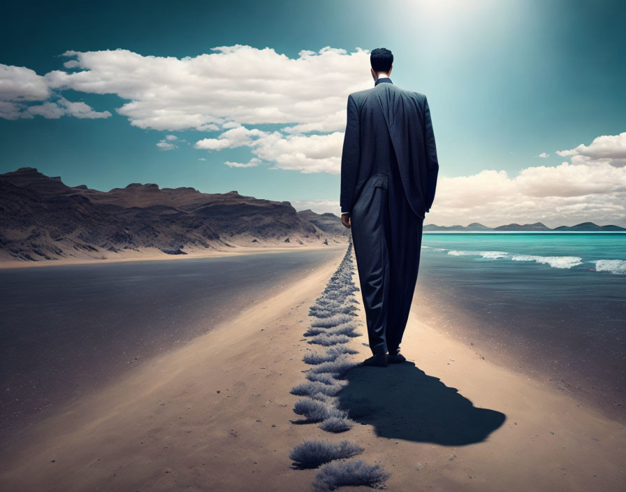 Man in suit on deserted beach with dramatic clouds and footsteps.