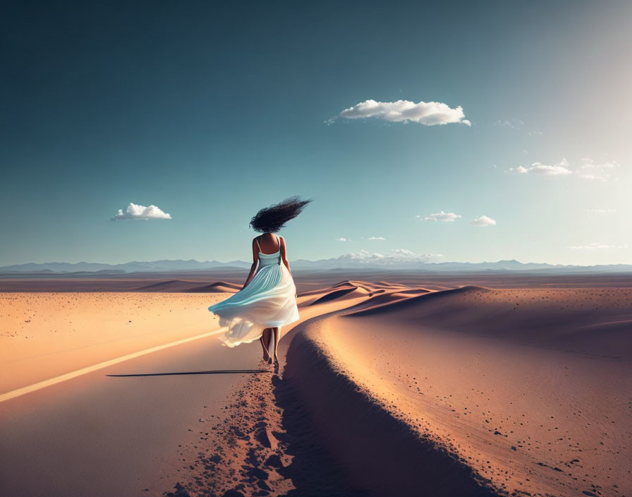 Woman in white dress walking desert ridge under clear blue sky