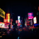 Vibrant night scene of Times Square with illuminated billboards and bustling traffic