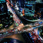 Vibrant cityscape at night with illuminated skyscrapers and busy highways