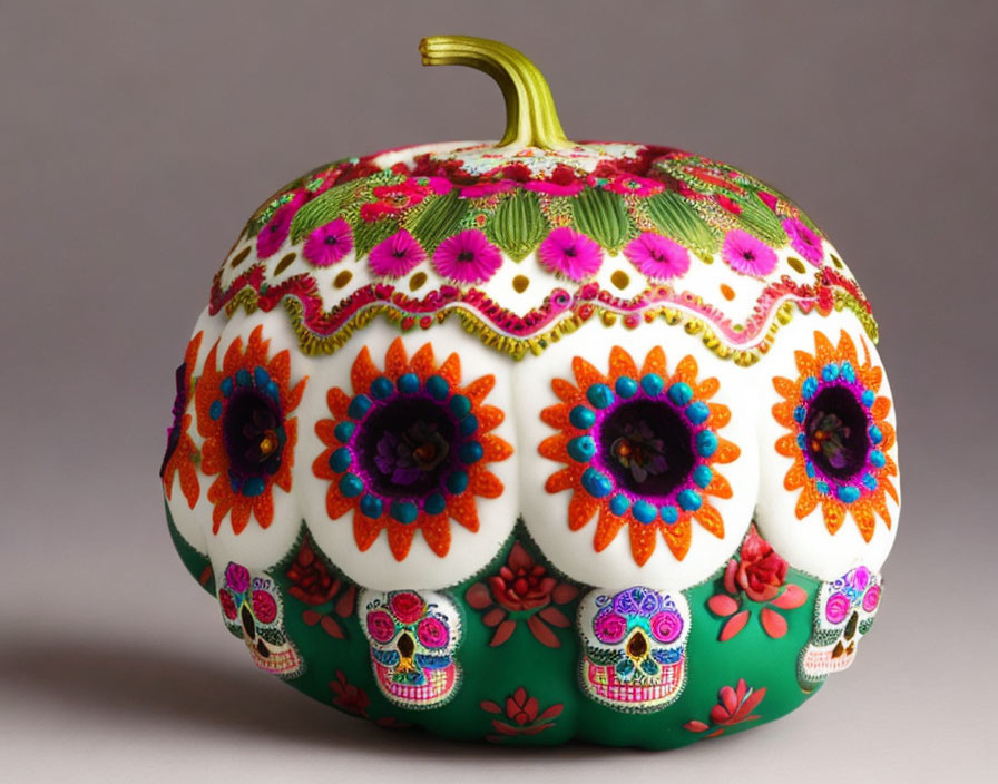 Colorful Day of the Dead Pumpkin with Skull and Floral Designs on Green Background