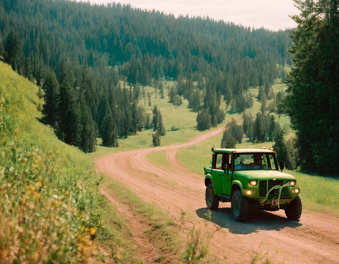 Green off-road vehicle driving through lush green fields and forests.