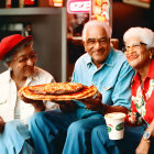 Elderly people in festive outfits with pizzas by restaurant window