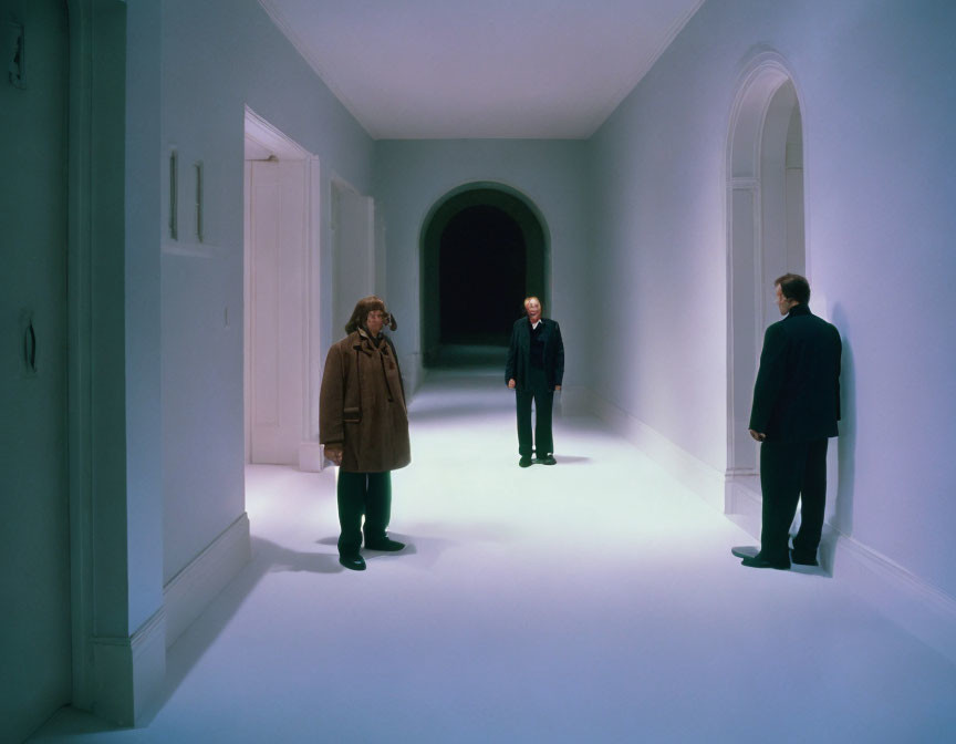 Three Men in Dimly Lit Hallway in Green Ambiance Face Off