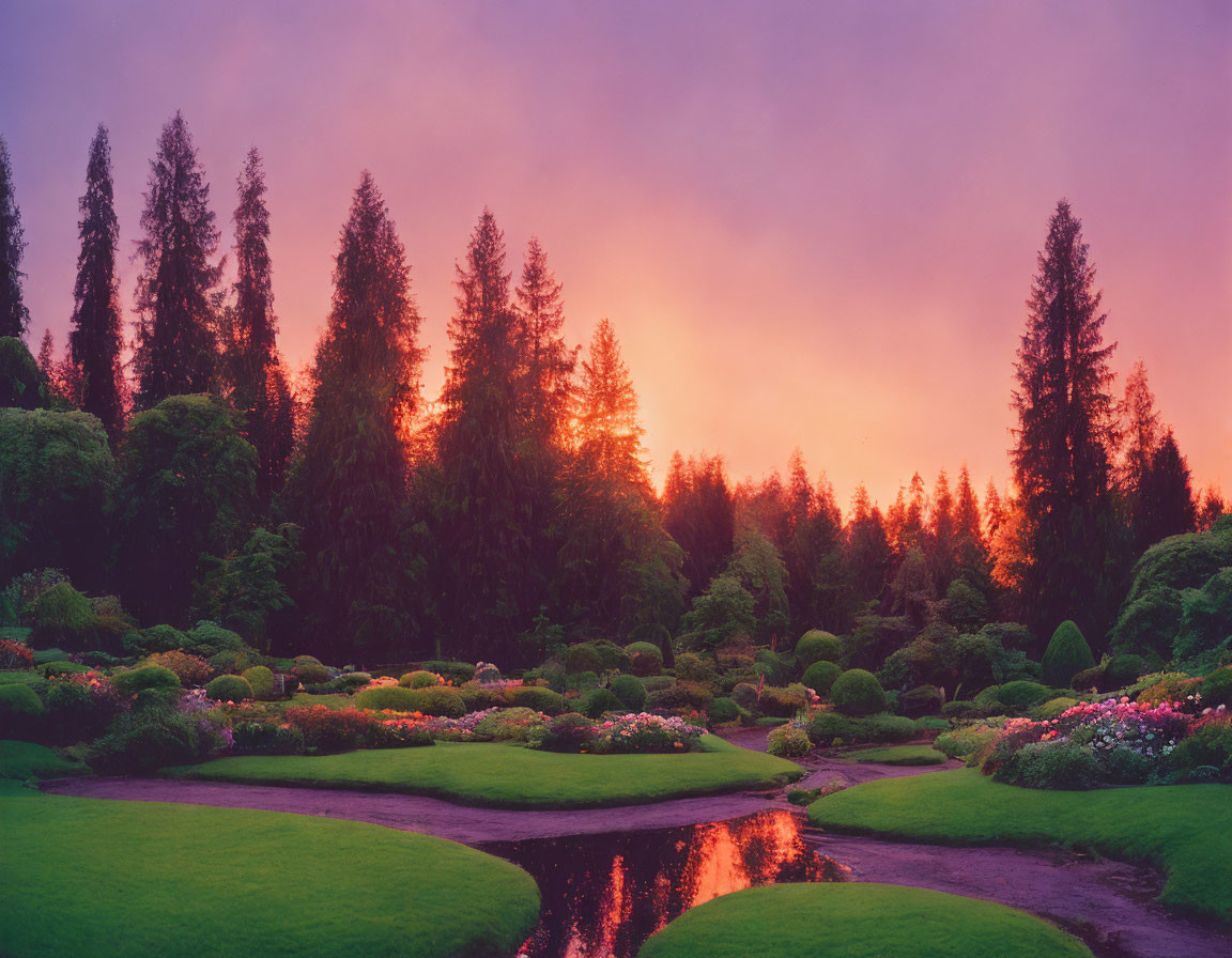 Tranquil garden with lush greenery and blooming flowers by meandering stream at sunset