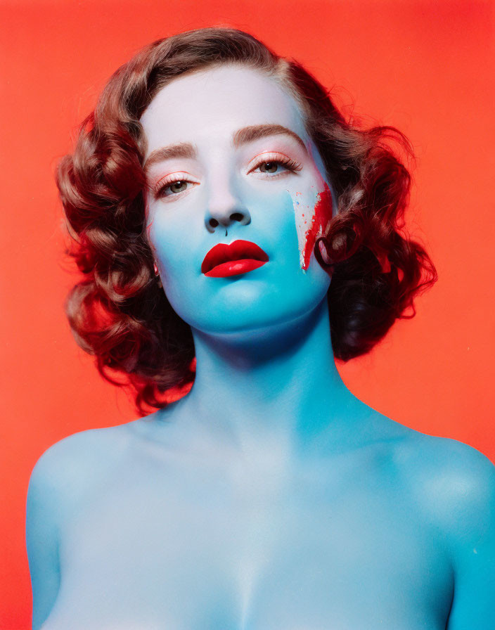 Surreal portrait of person with blue skin and red hair