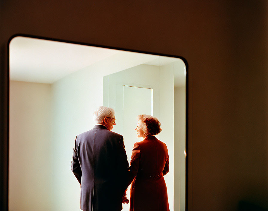 Elderly individuals in warmly lit room create intimate atmosphere