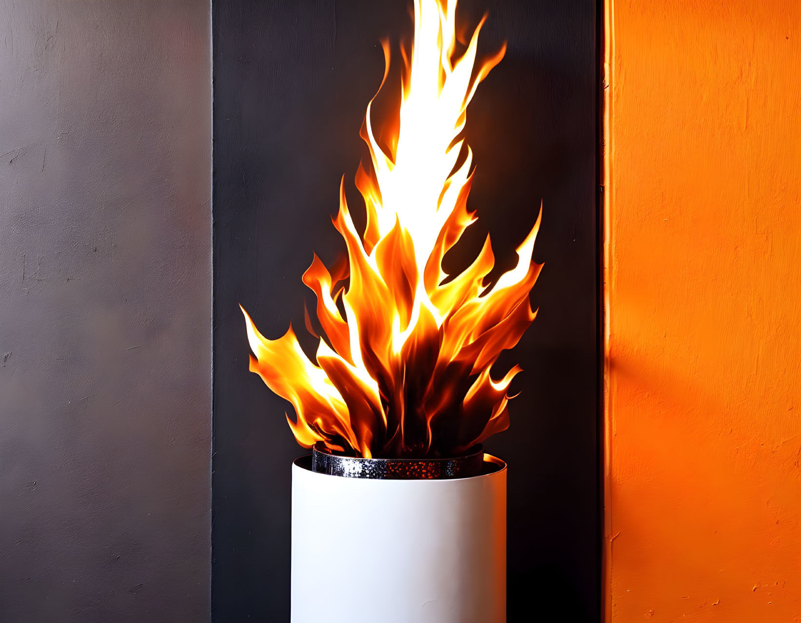 Intense flames from cylindrical container on orange and grey wall.