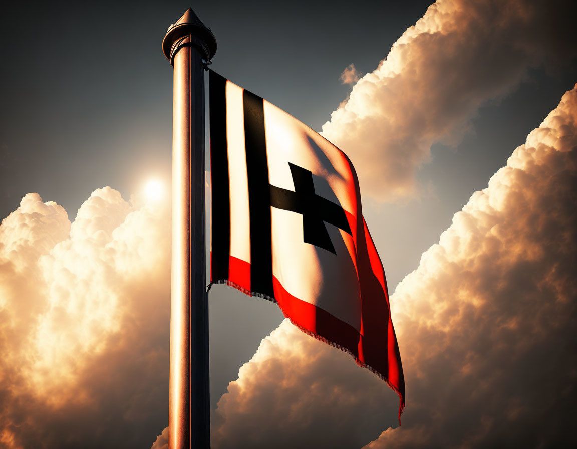 Red, white, black, and yellow flag on pole under dramatic sky