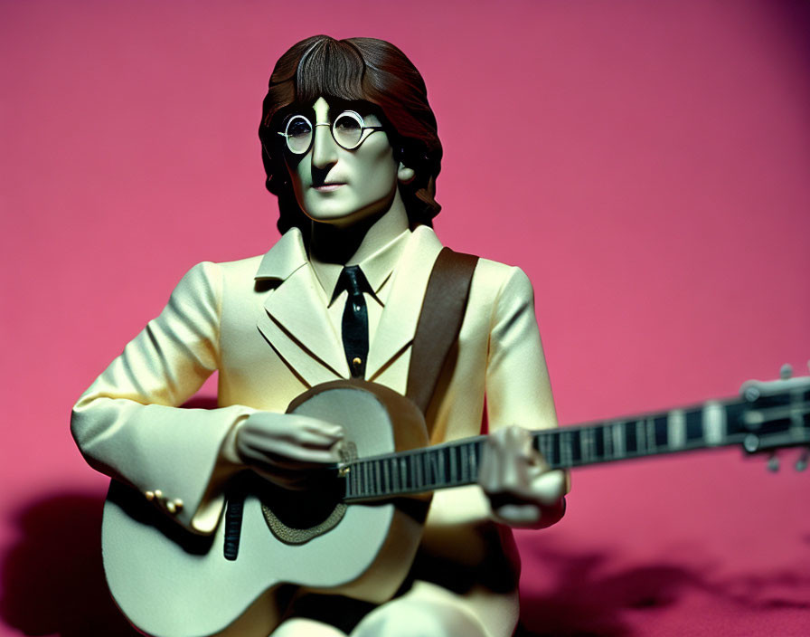 Man with Round Glasses Figurine Playing Acoustic Guitar in Cream Suit on Pink Background