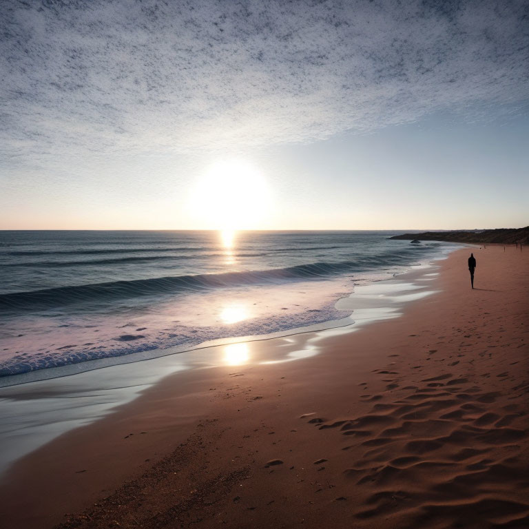 Solitary figure strolling on tranquil beach at sunset