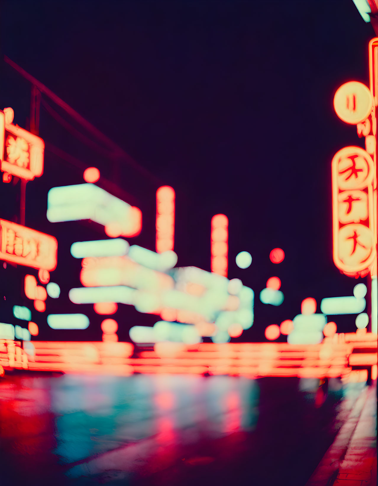 Blurred night cityscape with neon Chinese signs and lights